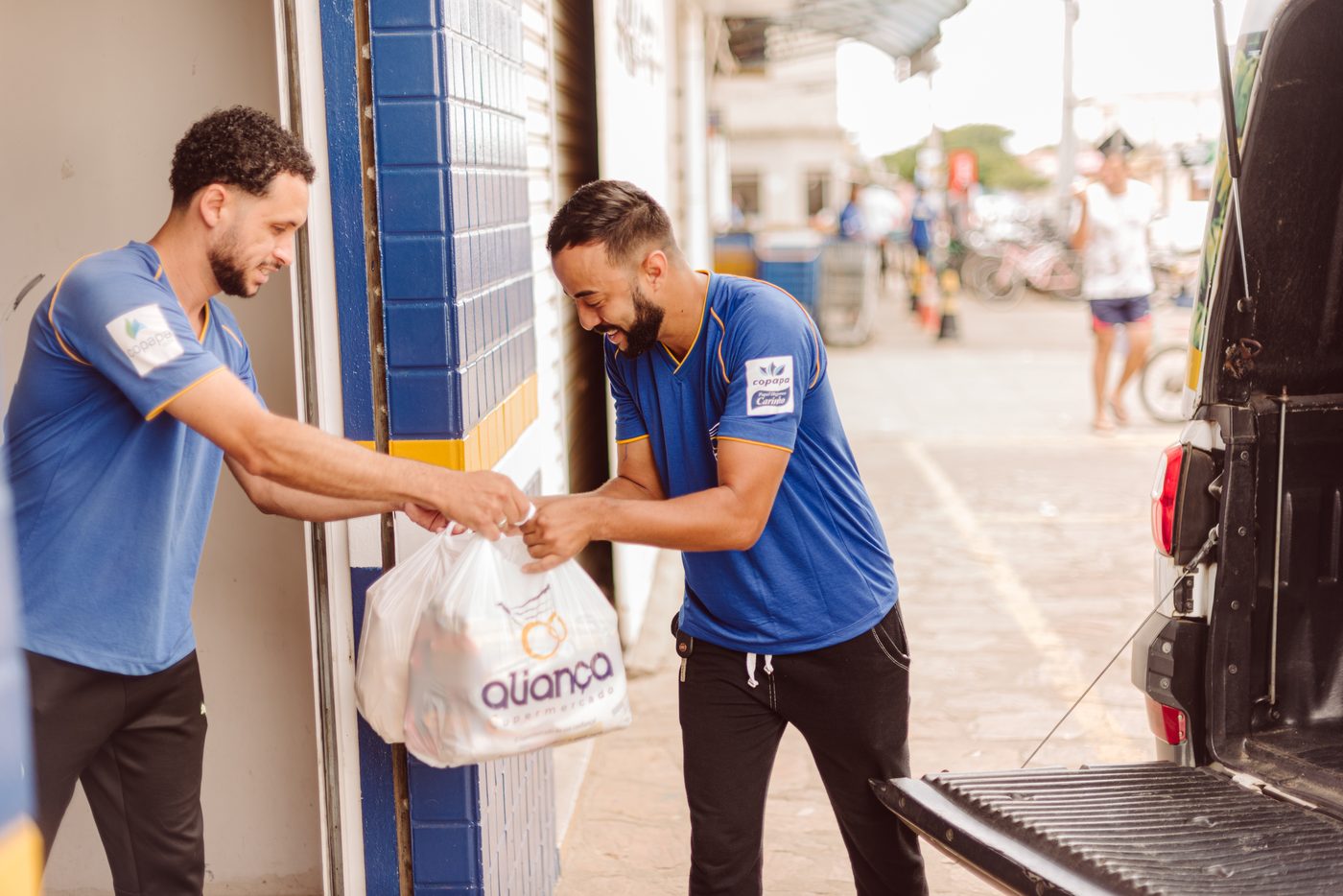 Equipe de entregas do Supermercado Aliança carregando as compras dos clientes
